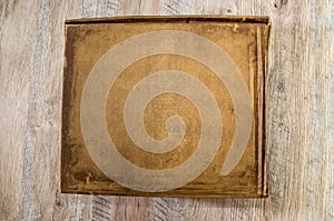 Brown cardboard box on a wooden background. View from above.