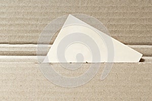 Brown cardboard envelopel with blank note paper card. Delivery shipping background