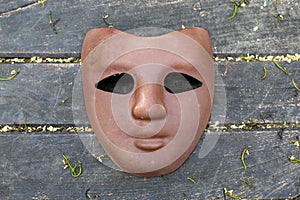 brown carnival mask on wooden background