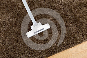 Brown carpet with vacuum cleaner