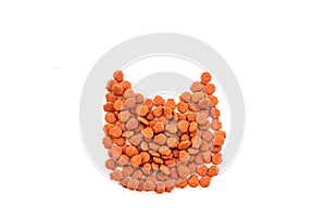 Brown cat food arranged in the shape of a cat\'s face on a white background.