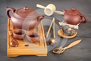Brown ceramic cups with a teapot on a special wooden tea tray prepared for a traditional Asian tea ceremon