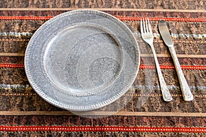 brown ceramic plate with fork and table knife
