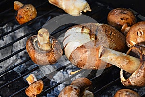 Brown champignons mushrooms on grill