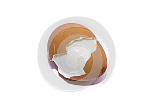 Brown chicken egg, cracked eggshell on a white background. isolate