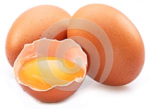 Brown chicken eggs and egg yolk isolated on white background