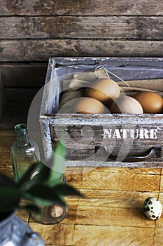 Brown chicken eggs in old wooden box, home farm