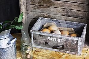 Brown chicken eggs in old wooden box, home farm