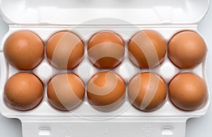 Brown chicken eggs in plastic packaging, close-up