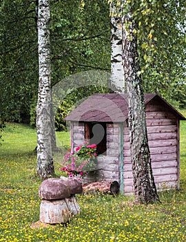 Brown children`s playhouse in the lawn