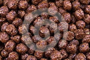 Brown chocolate breakfast balls cereal texture close up