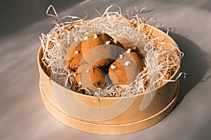 Brown chokolate sweet potato cake lie in a round wooden box on the table. homemade baking