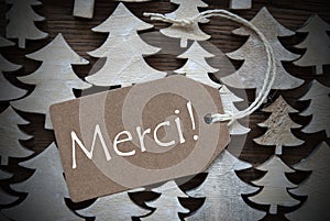 Brown Christmas Label With Merci Means Thank You