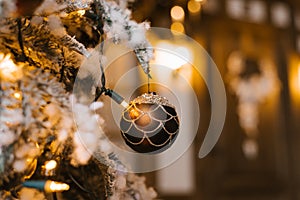 Brown Christmas tree toy on the tree with lights