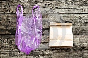 Brown clear empty blank craft paper bag and plastic bag on wooden background, Packaging template mock up.Zero waste. Copy space.