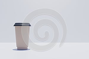Brown coffe 2 go cup on a white tabel copy space