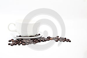 Brown coffee beans and coffee cup isolated