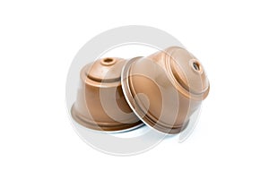 Brown coffee capsules for an automatic coffee machine isolated on white.