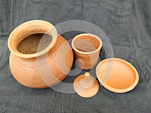 Brown Color hand Made Empty Pot, Bowl and Glass with Lid isolated on a Black Background
