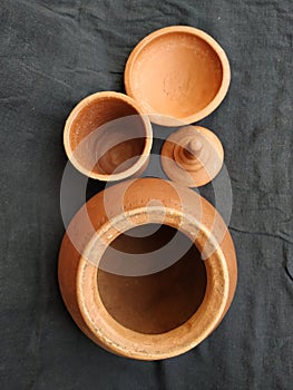 Brown Color hand Made Empty Pot, Bowl and Glass with Lid isolated on a Black Background