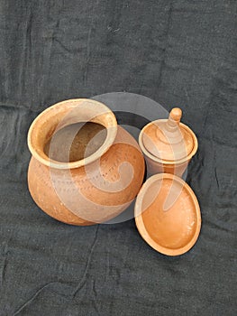 Brown Color hand Made Empty Pot, Bowl and Glass with Lid isolated on a Black Background