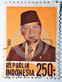 postage stamp printed in Indonesia with portrait image of Suharto the Indonesian second president, circa 1982