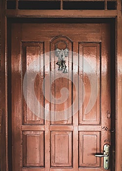 Brown color Wooden door with hanging Christmas bell ornamen photo