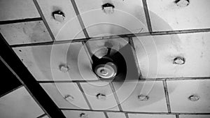 Brown colored ceiling fan moving isolated against a white background.