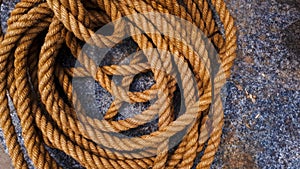 Brown colored reinforced jute rope on a rock