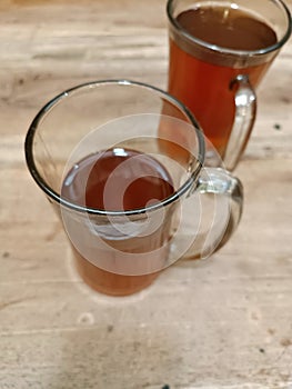 A brown colored tea glass with a blur focus