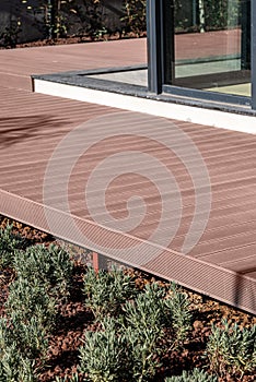Brown composite deck mounted on the porch of the house