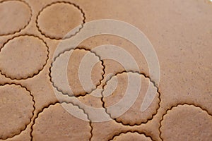 Brown cookie dough with round cut outs and copy space