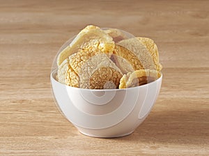 Brown crackers served in a white bowl photo