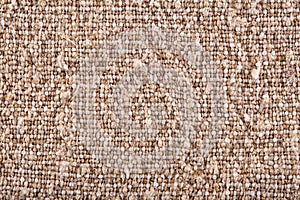 Brown crumpled burlap texture background. Macro of hessian cloth