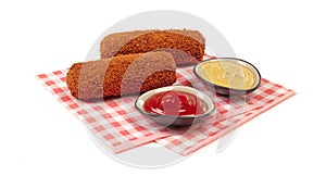 Brown crusty dutch kroket with sauces mustard and ketchup isolated