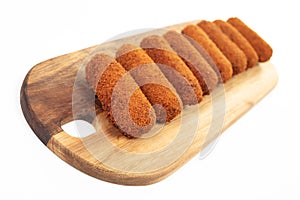 Brown crusty dutch kroketten on a serving tray isolated