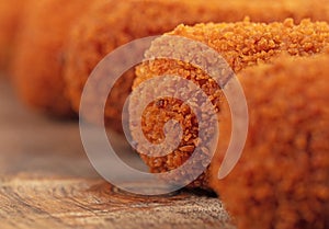 Brown crusty dutch kroketten on a serving tray, selective focus