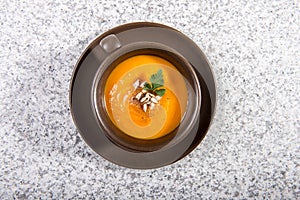 Brown cup with squash soup