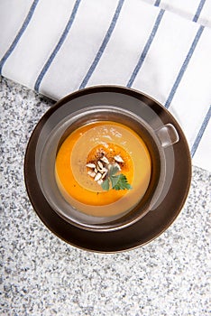 Brown cup with squash soup