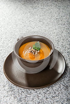 Brown cup with squash soup
