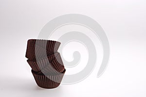 Brown cupcake cases on white background. Material for baking.