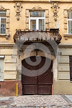The brown, decorated door to historic tenement house, Lviv, Ukraine