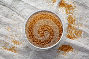 Brown Demerara Sugar in a Bowl, top view. Flat lay, overhead, from above