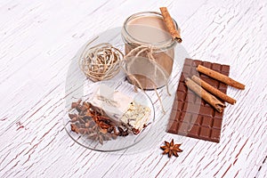 brown detox coctail with cinnamon sticks and chocolate lie on th