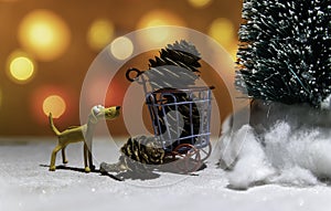 Brown dog watching Christmas tree and pine cone in basket from Christmas light background