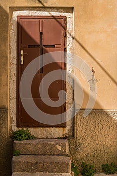 Brown door with a cross