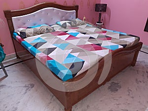 Brown Double Bed with Bedsheets and Pillows