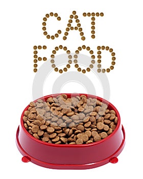Brown dry cat or dog food in red bowl on white backgrou