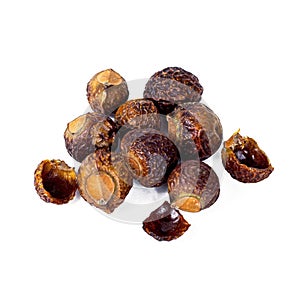 Brown dry soap nuts Soapberries, Sapindus Mukorossi for organic laundry and gentle natural skin care isolated on white backgroun