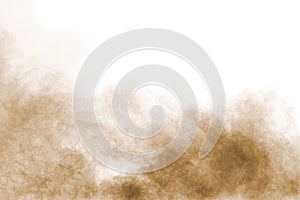 Brown dust cloud.Brown particles splattered on white background